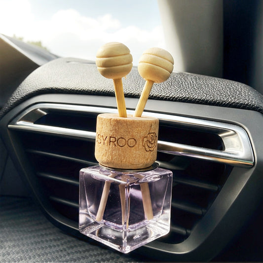 Black orchid car diffuser in clipped into car vent.