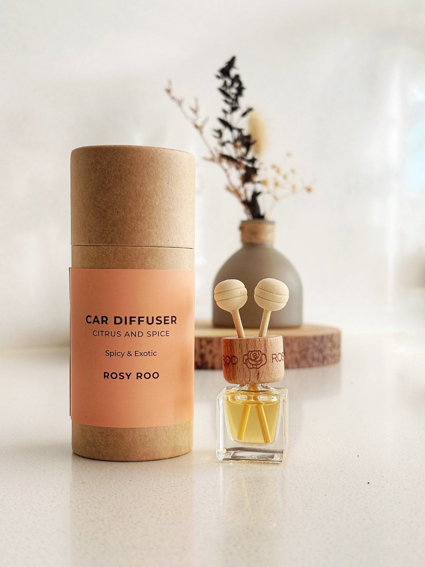 Rosy Roo Citrus and Spice car diffuser with packaging.